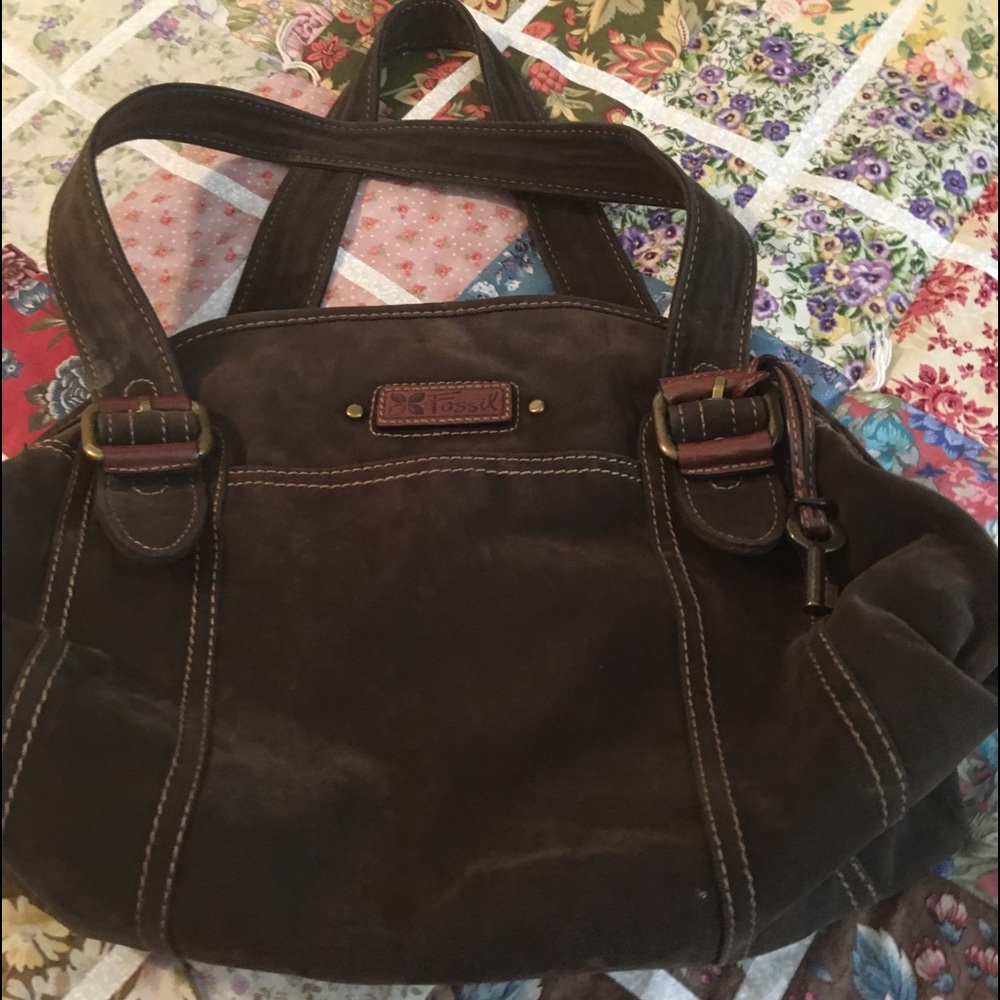 Fossil dark brown suede type canvas. Many pockets and storage inside.